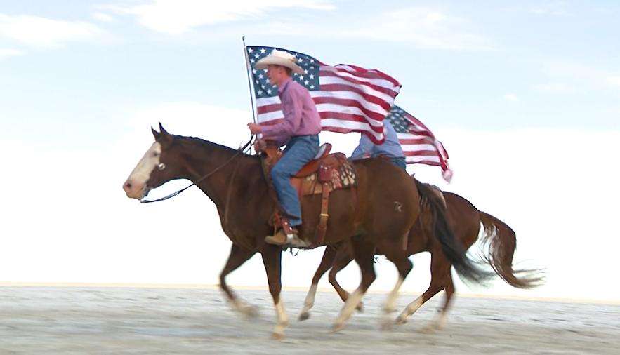 Riders carry flags across the Bonneville Salt Flats.