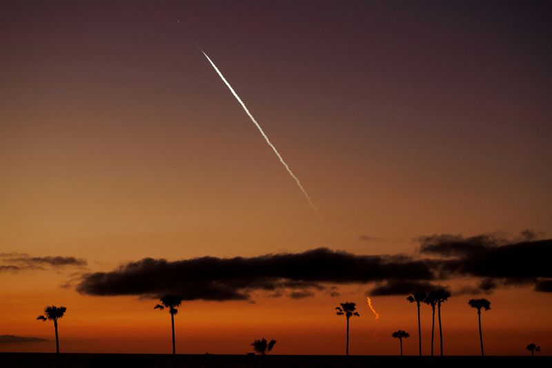 FILE PHOTO: An evening launch of a SpaceX Falcon 9 rocket carrying 22 Starlink satellites to low-Earth orbit is seen over the Pacific Ocean from Encinitas, California, U.S., April 1, 2024.
