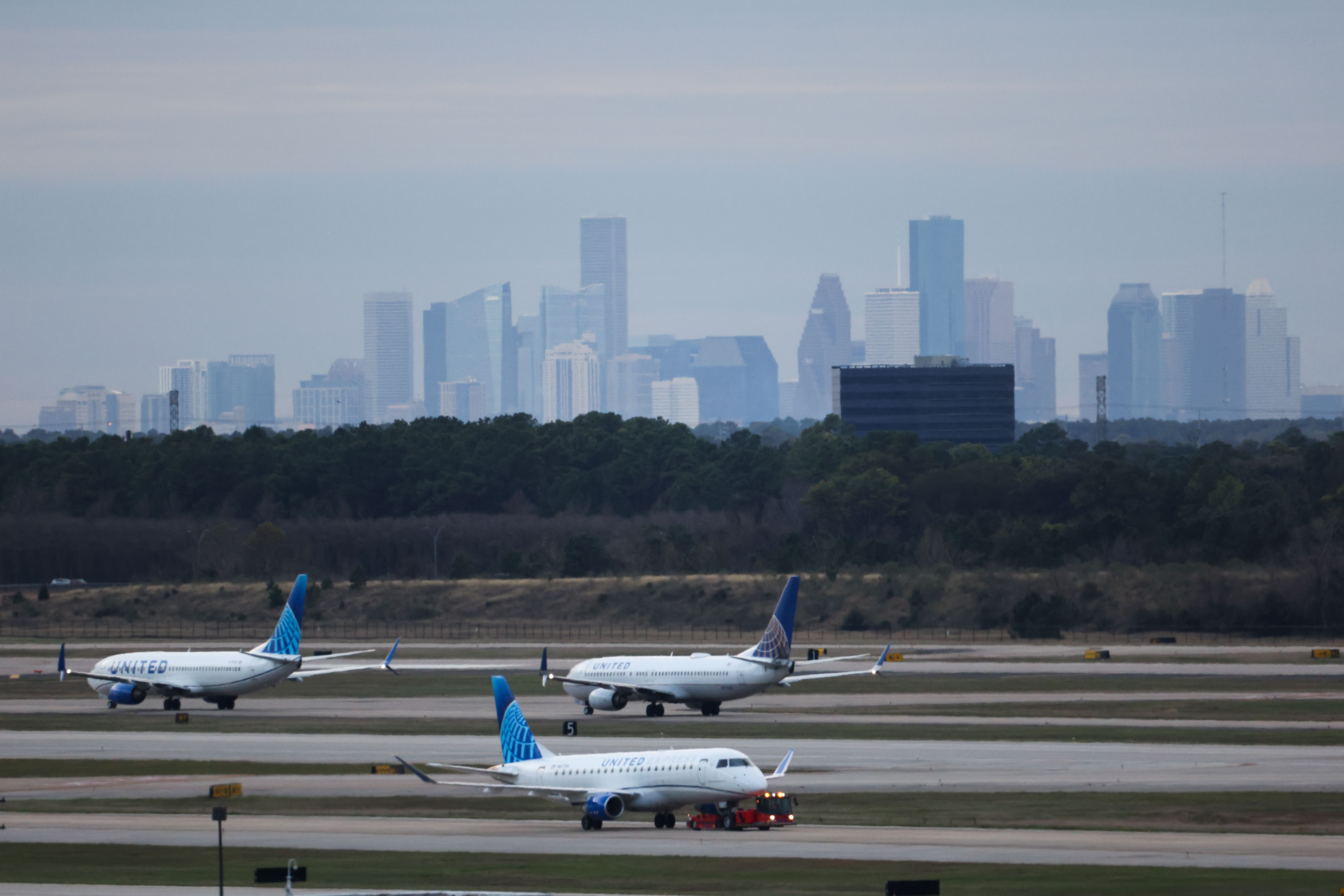 Planes line up to depart from George Bush Intercontinental Airport (IAH) in Houston, Texas, on December 29, 2025.