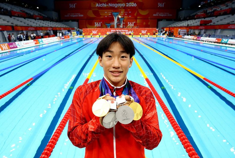 Asian Games - Aichi-Nagoya 2026 - Swimming - Tokyo Aquatics Centre, Koto, Tokyo, Japan - September 25, 2026 Japan's Shin Ohashi poses with his medals after the end of the final session
