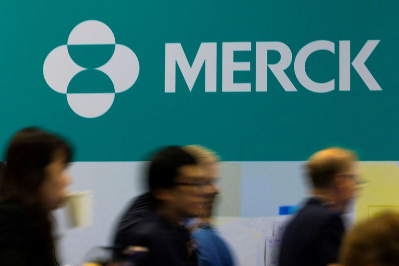 FILE PHOTO: Attendees walk past the Merck logo at the BIO International Convention 2026, a meeting of pharmaceutical and biotechnology leaders in San Diego, California, U.S. June 23, 2026.