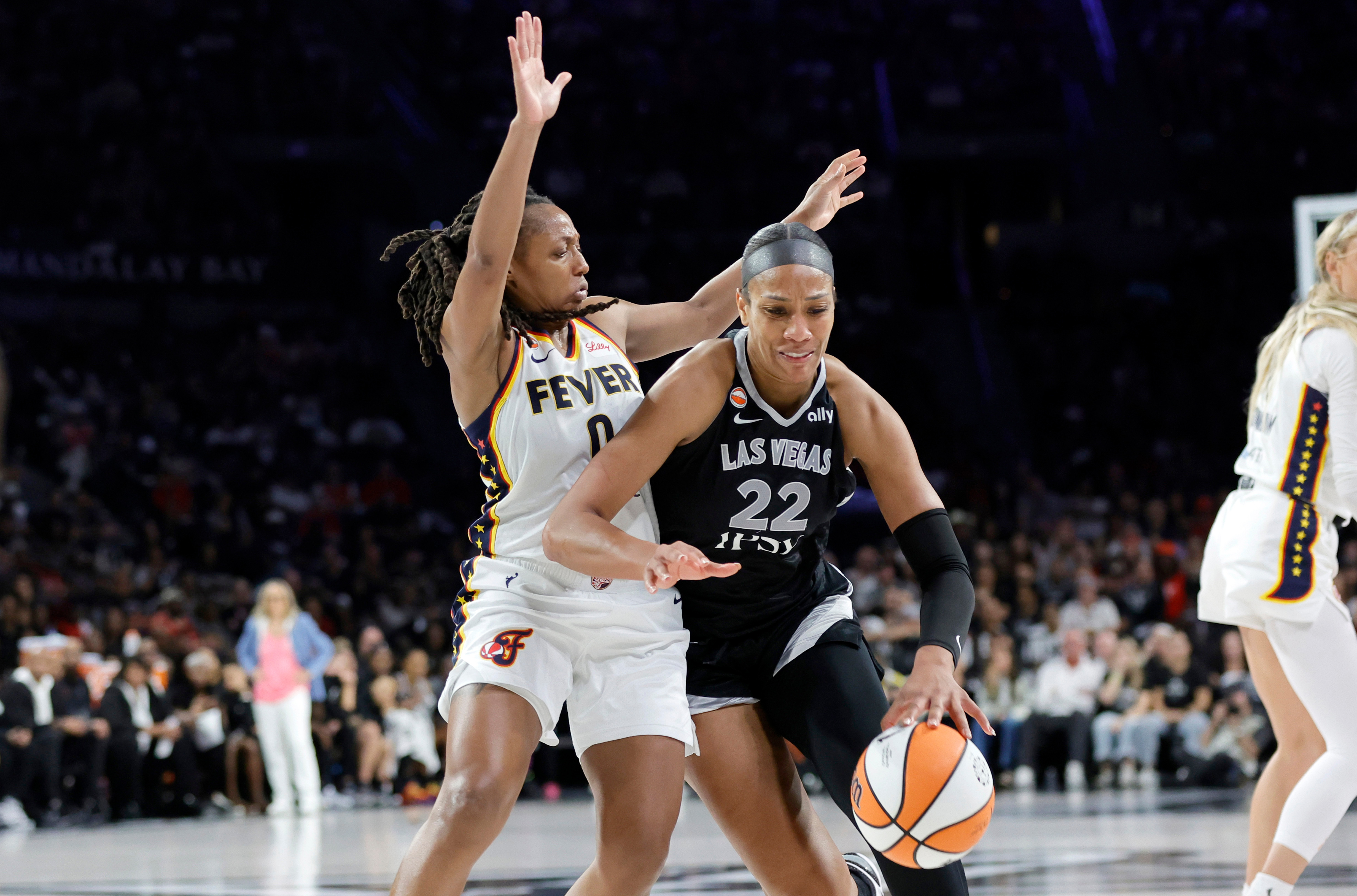Las Vegas Aces center A'ja Wilson (22) drives against Indiana Fever guard Kelsey Mitchell (0) during the second half in Game 1 of a WNBA basketball first-round playoff series Sunday, Sept. 27, 2026, in Las Vegas. 