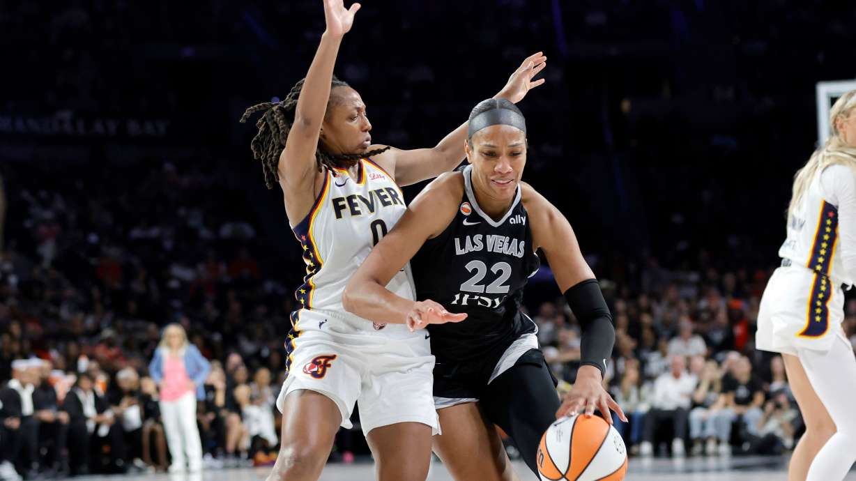 Las Vegas Aces center A'ja Wilson (22) drives against Indiana Fever guard Kelsey Mitchell (0) during the second half in Game 1 of a WNBA basketball first-round playoff series Sunday, Sept. 27, 2026, in Las Vegas.