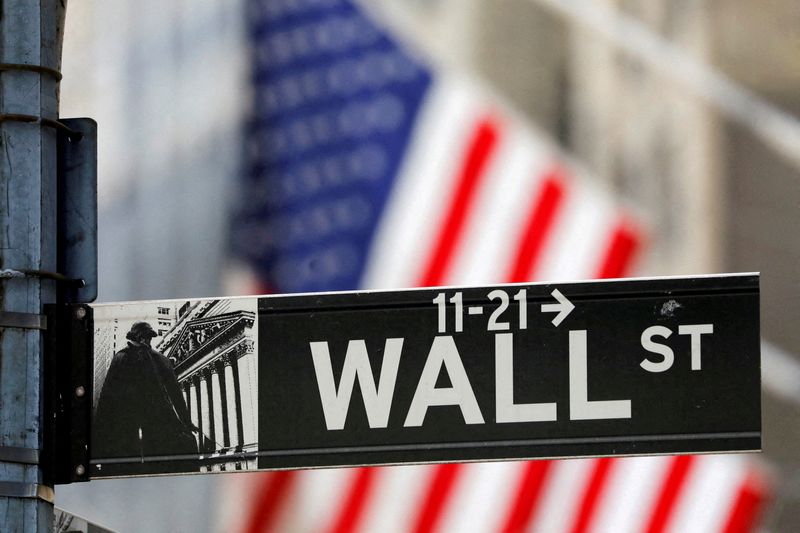 FILE PHOTO: A street sign for Wall Street is seen outside the New York Stock Exchange (NYSE) in New York City, New York, U.S., July 19, 2021.