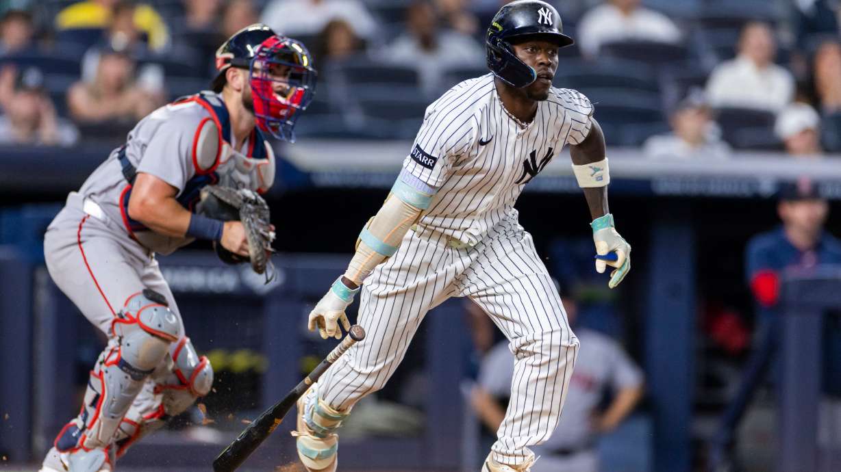 New York Yankees' Jazz Chisholm Jr., right, watches after he hit into a fielder's choice in the eighth inning during the second baseball game of a doubleheader against the Boston Red Sox, Saturday, Aug. 29, 2026, in New York.