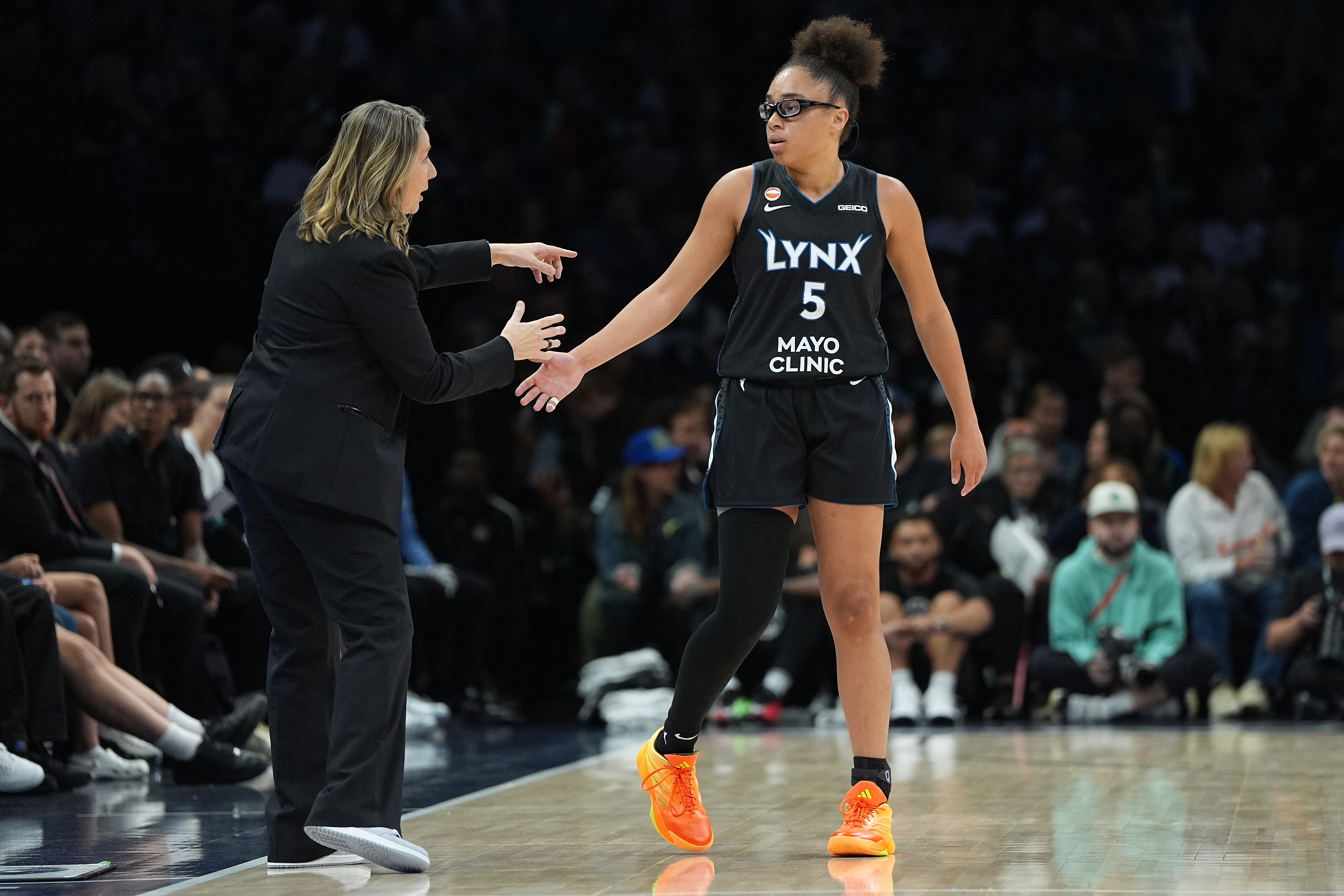 Minnesota Lynx head coach Cheryl Reeve and guard Olivia Miles (5) talk during the first half of a WNBA basketball game against the New York LibertyFriday, Sept. 18, 2026, in Minneapolis. 