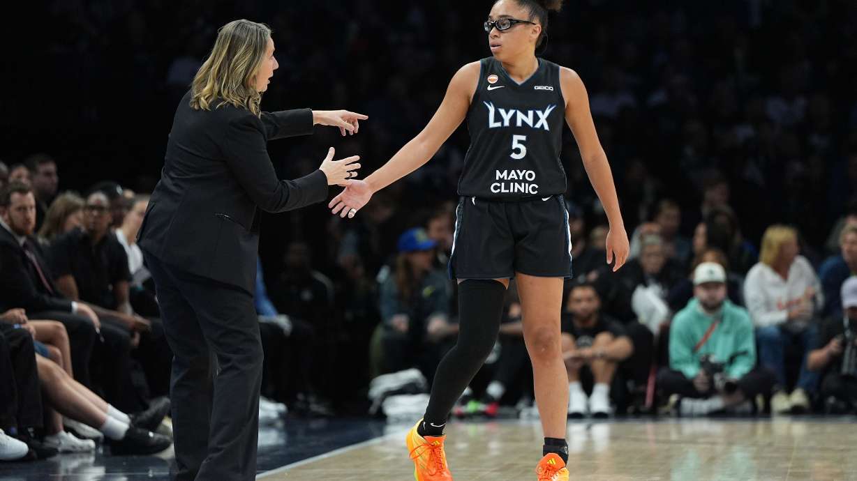 Minnesota Lynx head coach Cheryl Reeve and guard Olivia Miles (5) talk during the first half of a WNBA basketball game against the New York LibertyFriday, Sept. 18, 2026, in Minneapolis.