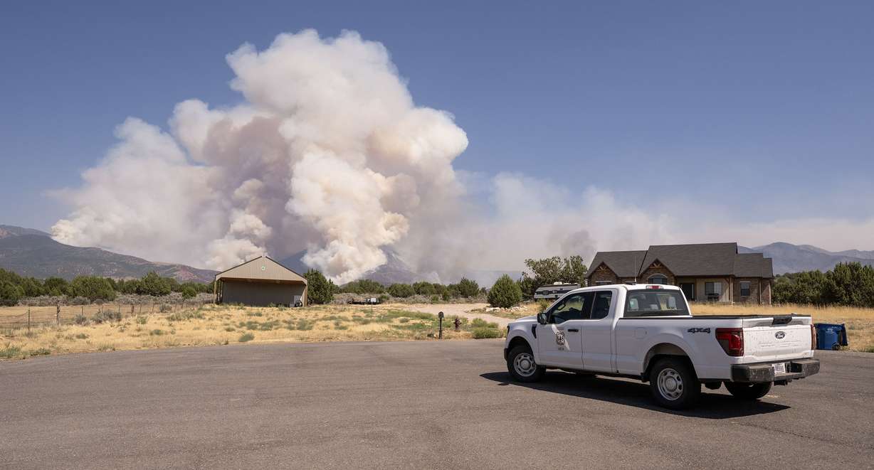 A Forest Service employee watches the Widemouth 2 Fire as it burned in the mountains east of Fillmore on Aug. 4, 2026.
