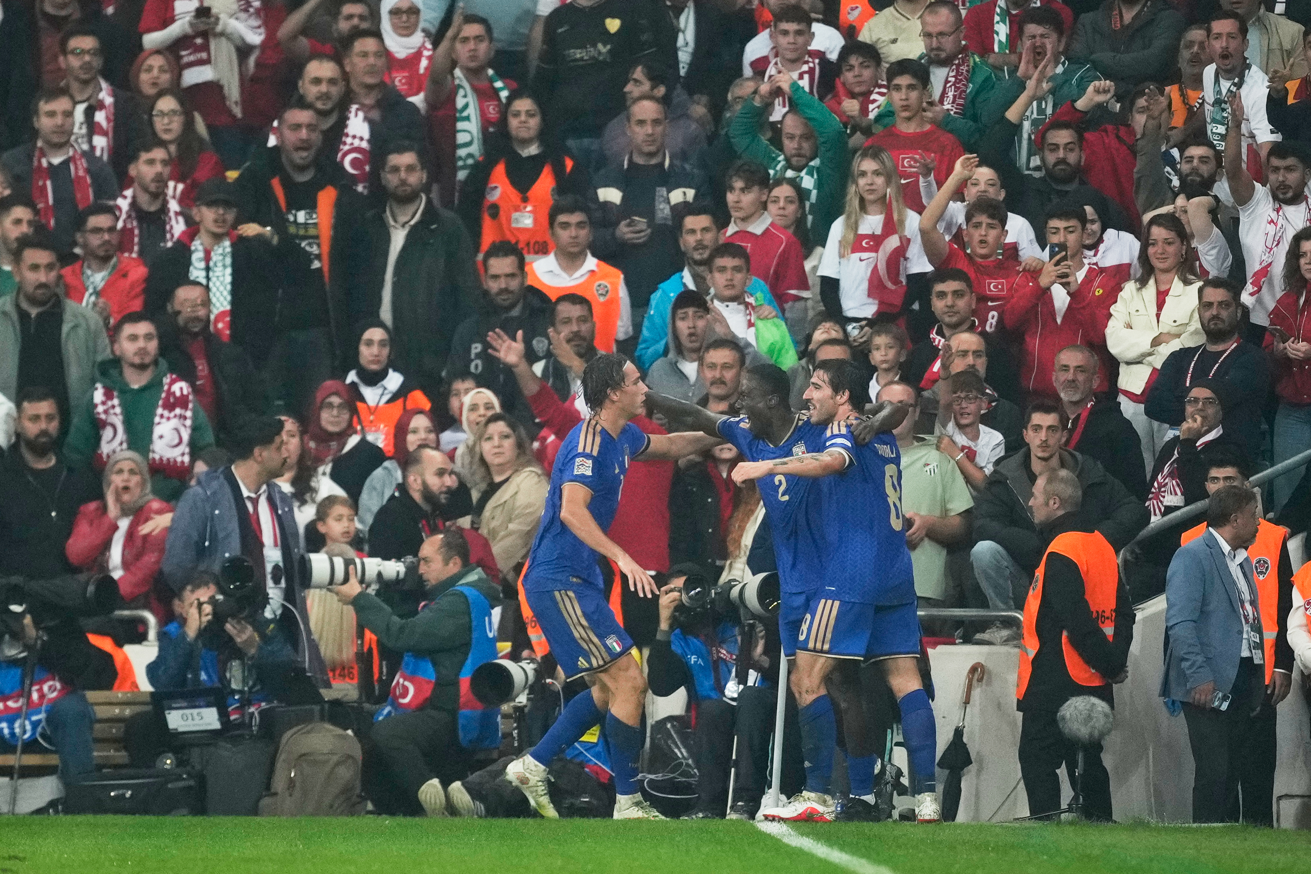 Italy's Michael Kayode, centre, celebrates with teammates after scoring his side's third goal during the UEFA Nations League soccer match between Turkey and Italy in Bursa, Turkey, Monday, Sept. 28, 2026. 