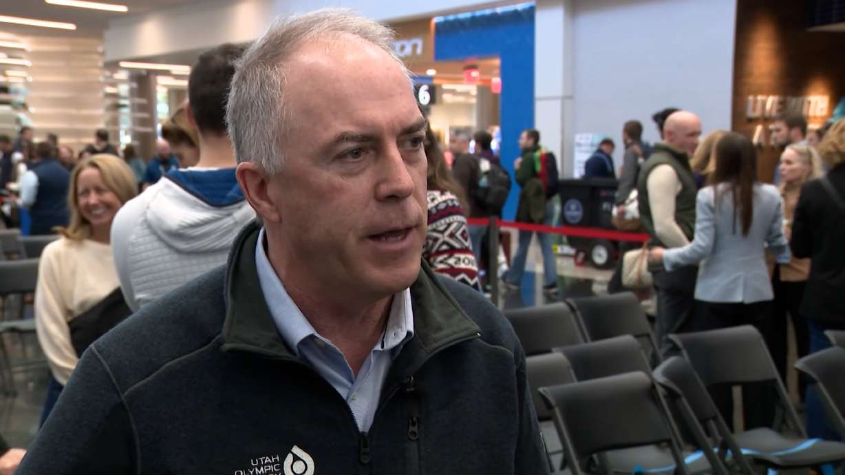 Colin Hilton speaks to Alex Cabrero in 2025 at the Salt Lake City International Airport. Hilton's legacy lives on through a new initiative and a tribute beneath the Olympic Oval ice.
