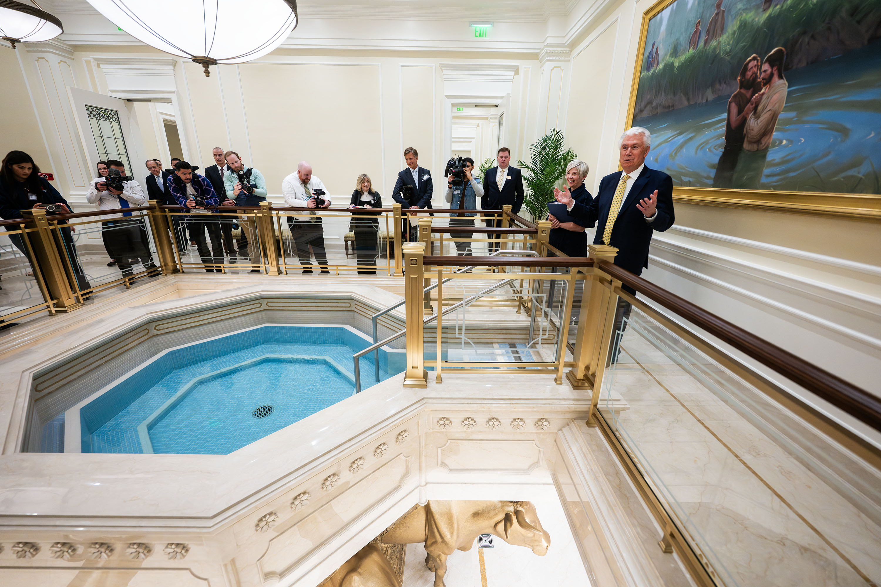 President Dieter F. Uchtdorf and President Emily Belle Freeman lead members of the media on a tour showing a full-scale replica of a temple baptistry room in the Temple Square Visitors' Center in Salt Lake City on April 13.