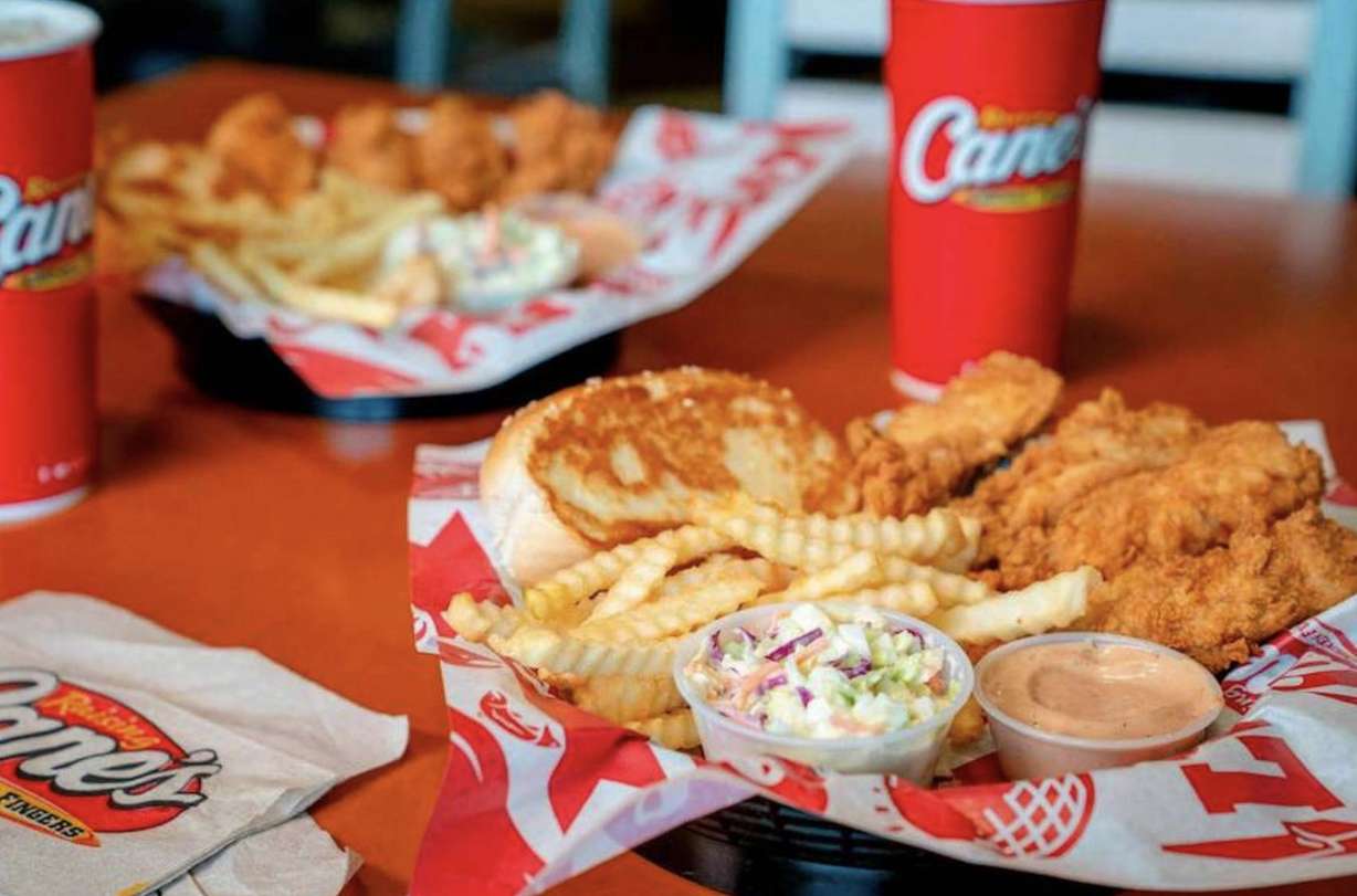 The Box Combo, one of Raising Cane’s most popular meals, features chicken fingers, crinkle-cut fries, Texas toast, coleslaw, and Cane’s Sauce.