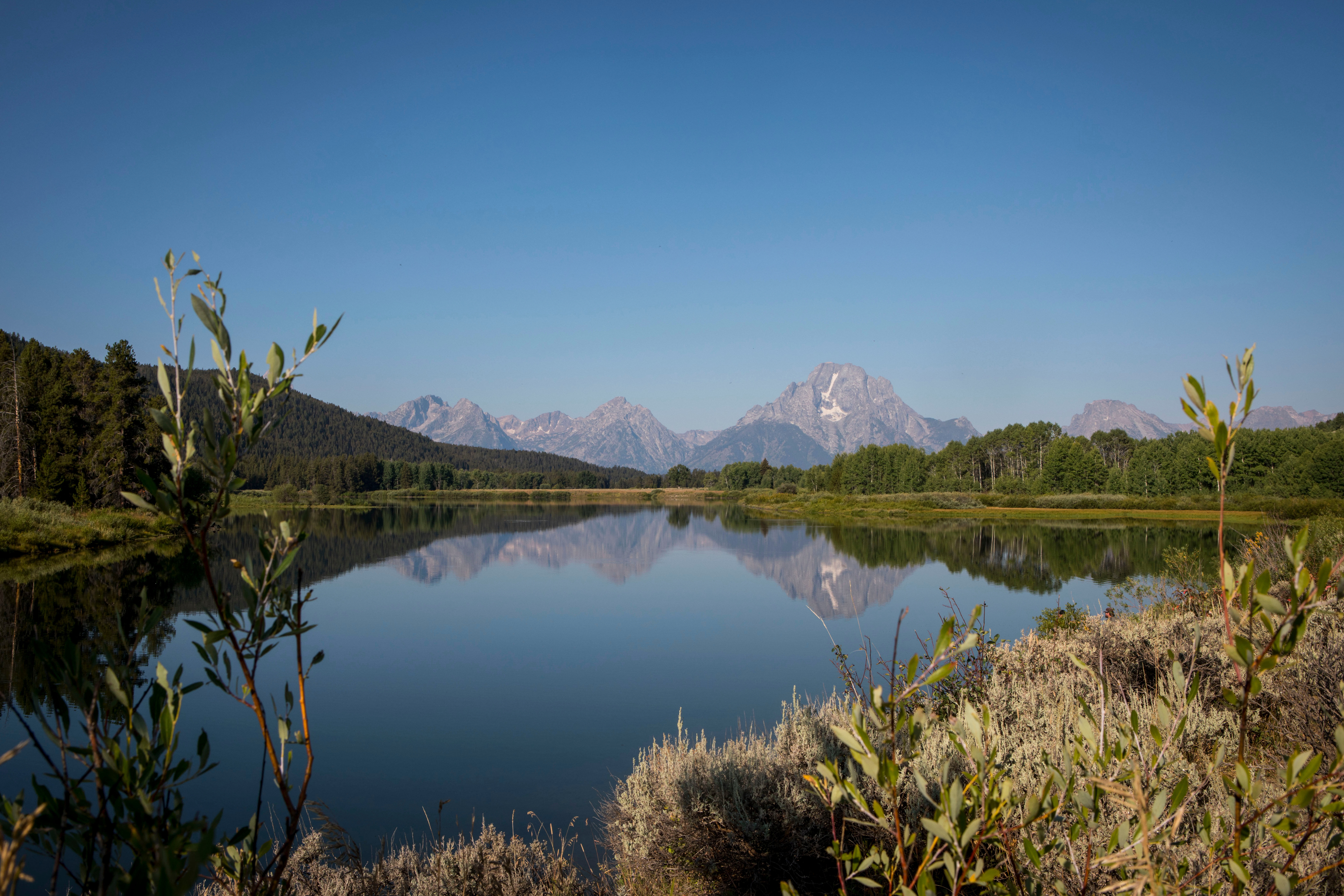 FILE - The Teton mountains reflect on Oxbow Bend in Grand Teton National Park in Moran, Wyo., Aug. 22, 2025. 