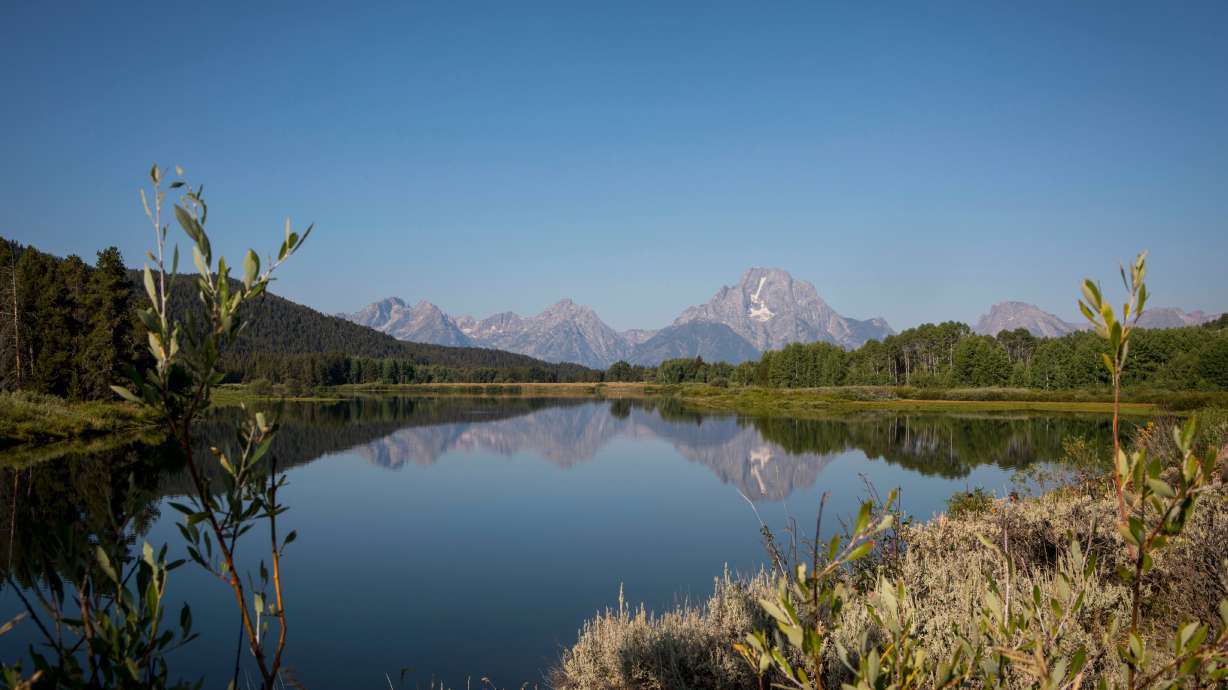 FILE - The Teton mountains reflect on Oxbow Bend in Grand Teton National Park in Moran, Wyo., Aug. 22, 2025.
