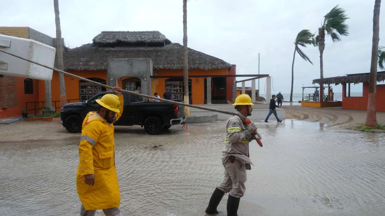 Workers pull a boat to shore as Hurricane Polo approaches Puerto San Carlos, Baja California Sur state, Mexico, Monday. Polo made landfall on Tuesday as a Category 2 hurricane.