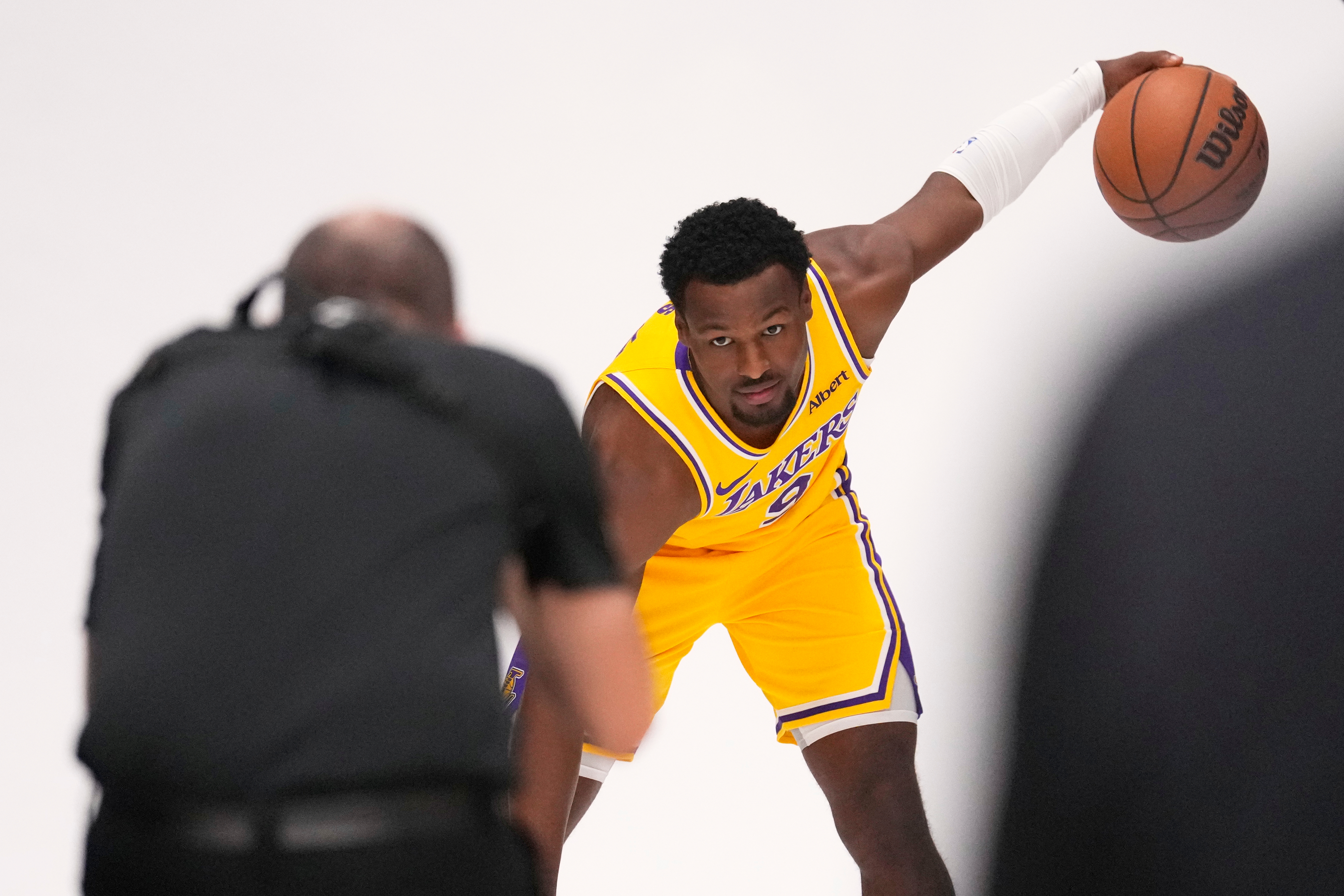 Los Angeles Lakers guard Bronny James poses for pictures with NBA photographer Adam Pantozzi during media day Monday, Sept. 28, 2026, in El Segundo, Calif. 