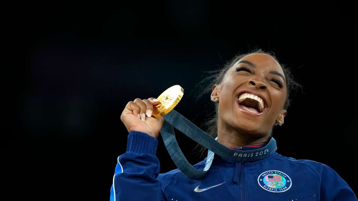 FILE - Simone Biles, of the United States, celebrates after winning the gold medal at the medal ceremony during the women's artistic gymnastics individual vault finals at Bercy Arena at the 2024 Summer Olympics, on Aug. 3, 2024, in Paris, France.