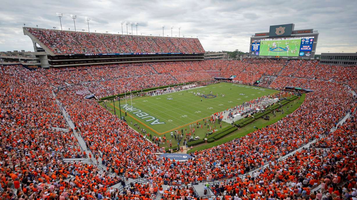 FILE - Fans file Jordan-Hare Stadium during the first half an NCAA football game between the Oklahoma and Auburn, Sept. 28, 2024, in Auburn, Ala.