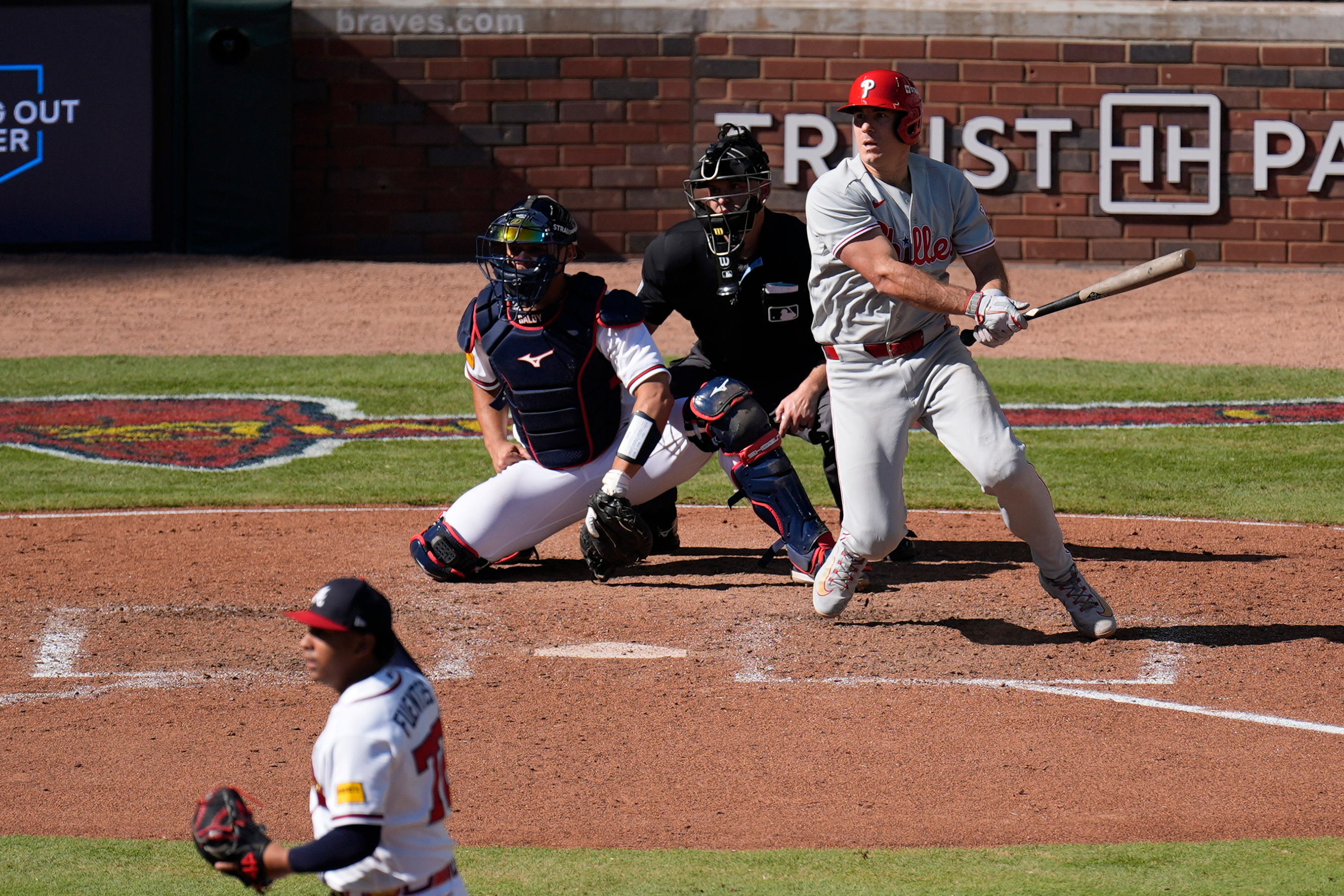Philadelphia Phillies' J.T. Realmuto hits a two-run triple off Atlanta Braves pitcher Didier Fuentes (72) in the seventh inning during Game 1 of baseball's National League Wild Card Series Tuesday, Sept. 29, 2026, in Atlanta. 