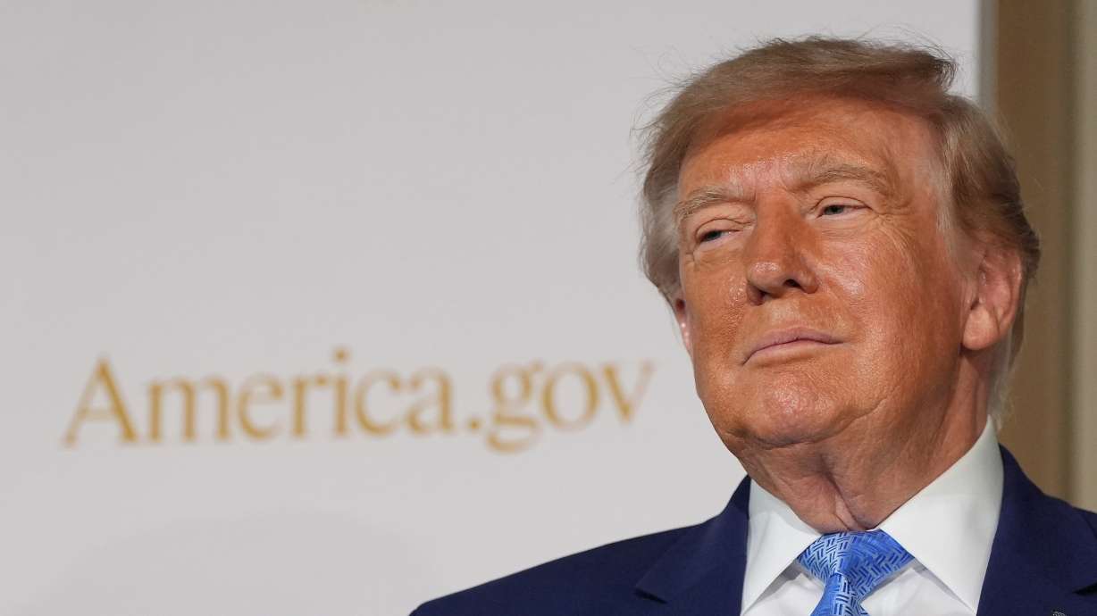 President Donald Trump stands on stage at the Andrew W. Mellon Auditorium, Tuesday, in Washington. A federal watchdog's ruling has escalated a fight between the White House and congressional appropriators over who holds budget authority.