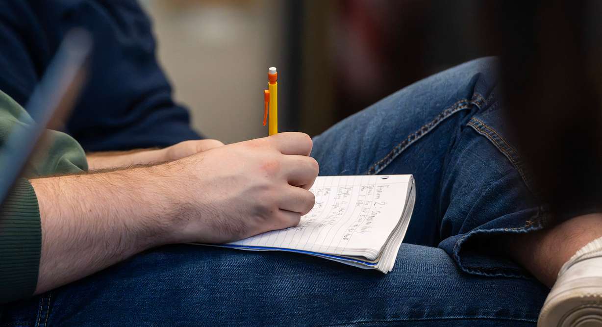 A student takes notes on a notepad while listening to Rep. Mike Kennedy speak with state Sen. Todd Weiler, R-Woods Cross, at Sutherland Institute's Congressional Series at the University of Utah in Salt Lake City on Tuesday. Conservatives are divided on in vitro fertilization and surrogacy.