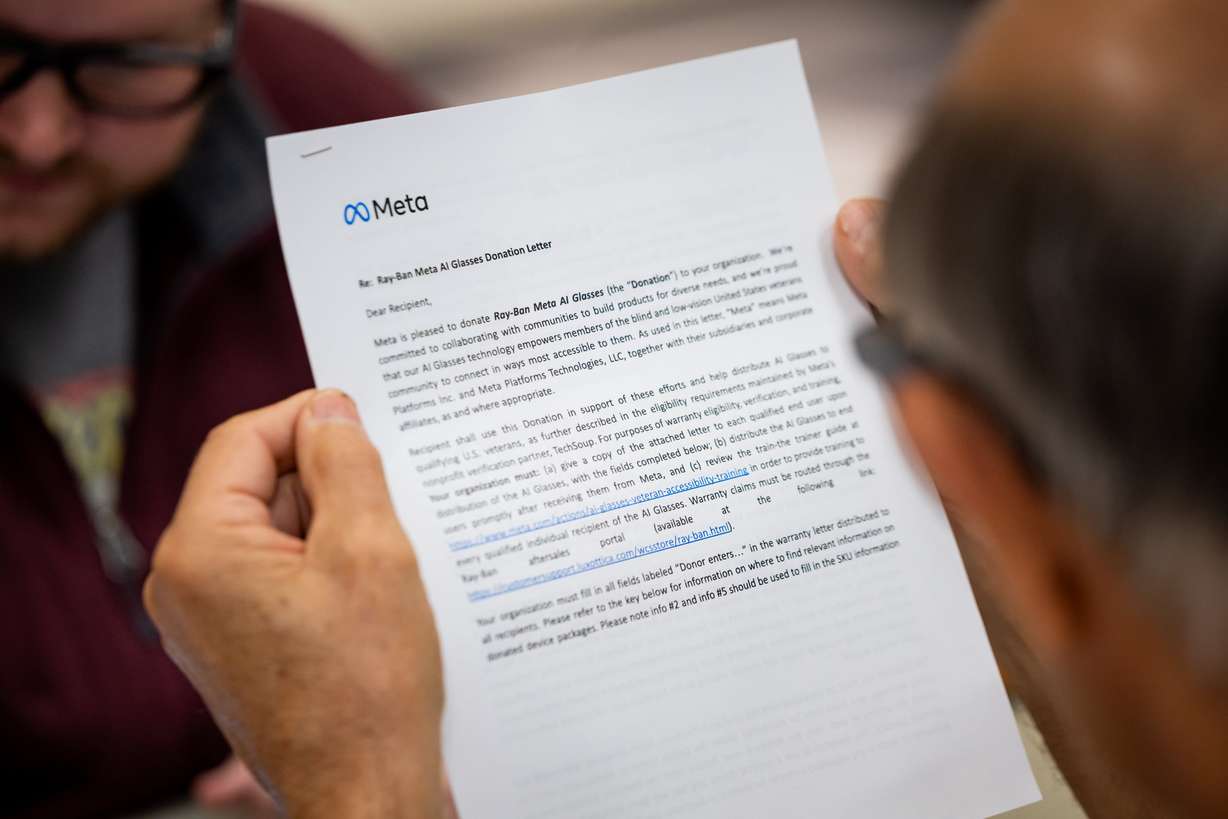 Ed Riding, a veteran, reads a paper while wearing his Ray-Ban Meta AI glasses during training on how to use the glasses to improve daily life at the Utah Division of Services for the Blind and Visually Impaired in Salt Lake City on Tuesday.