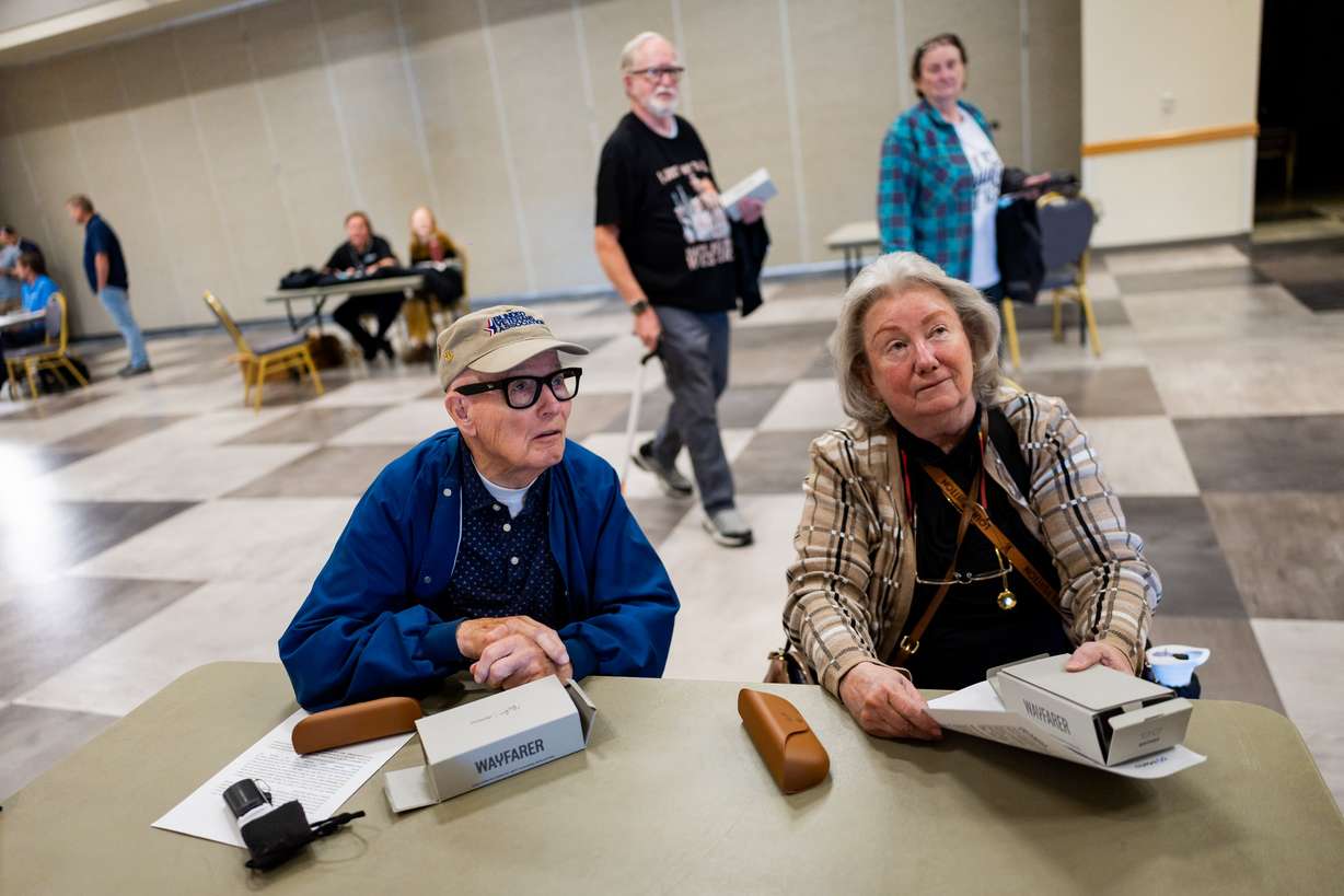 Dominique Lawless, who is the national program director at the Blinded Veterans Association and blind herself, off camera, helps give Ray-Ban Meta AI glasses to blind veterans like Dean Anderson, left, and his wife Colleen Anderson, right, and provides training on how to use the glasses to improve daily life at the Utah Division of Services for the Blind and Visually Impaired in Salt Lake City on Tuesday.