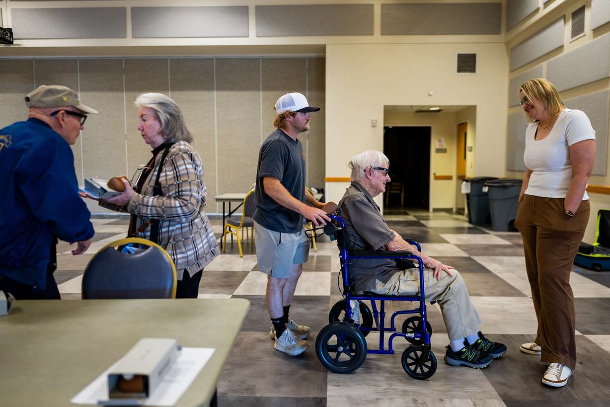 Roger Anderson, a veteran who is blind, from Idaho, center, leaves after receiving Ray-Ban Meta AI glasses and training on how to use the glasses to improve daily life along with other blind veterans at the Utah Division of Services for the Blind and Visually Impaired in Salt Lake City on Tuesday.
