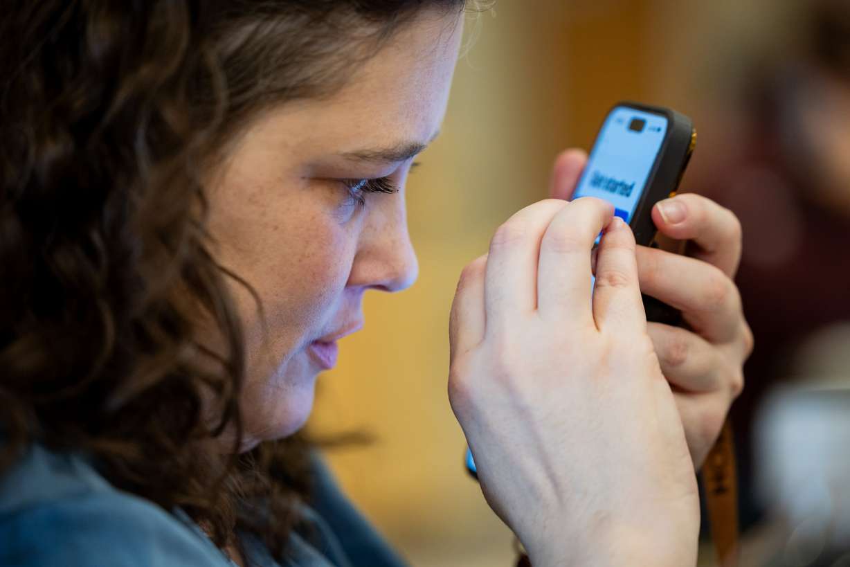 Dominique Lawless, who is the national program director at the Blinded Veterans Association and blind herself, helps give Ray-Ban Meta AI glasses to blind veterans and provides training on how to use the glasses to improve daily life at the Utah Division of Services for the Blind and Visually Impaired in Salt Lake City on Tuesday.