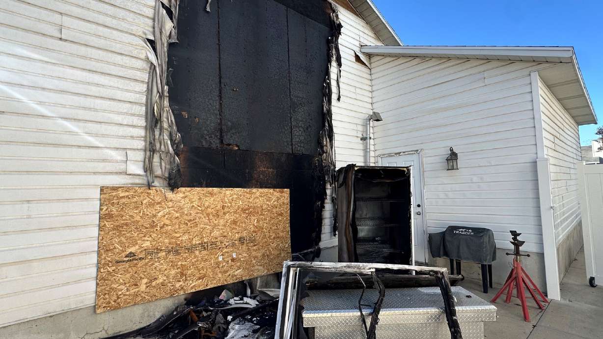 Damage from a fire on the side of Megan Rushton's home. Fire and smoke also damaged the inside. A West Jordan family is searching for a new place to live after a fire, sparked by a battery-powered children's toy car, heavily damaged their home.