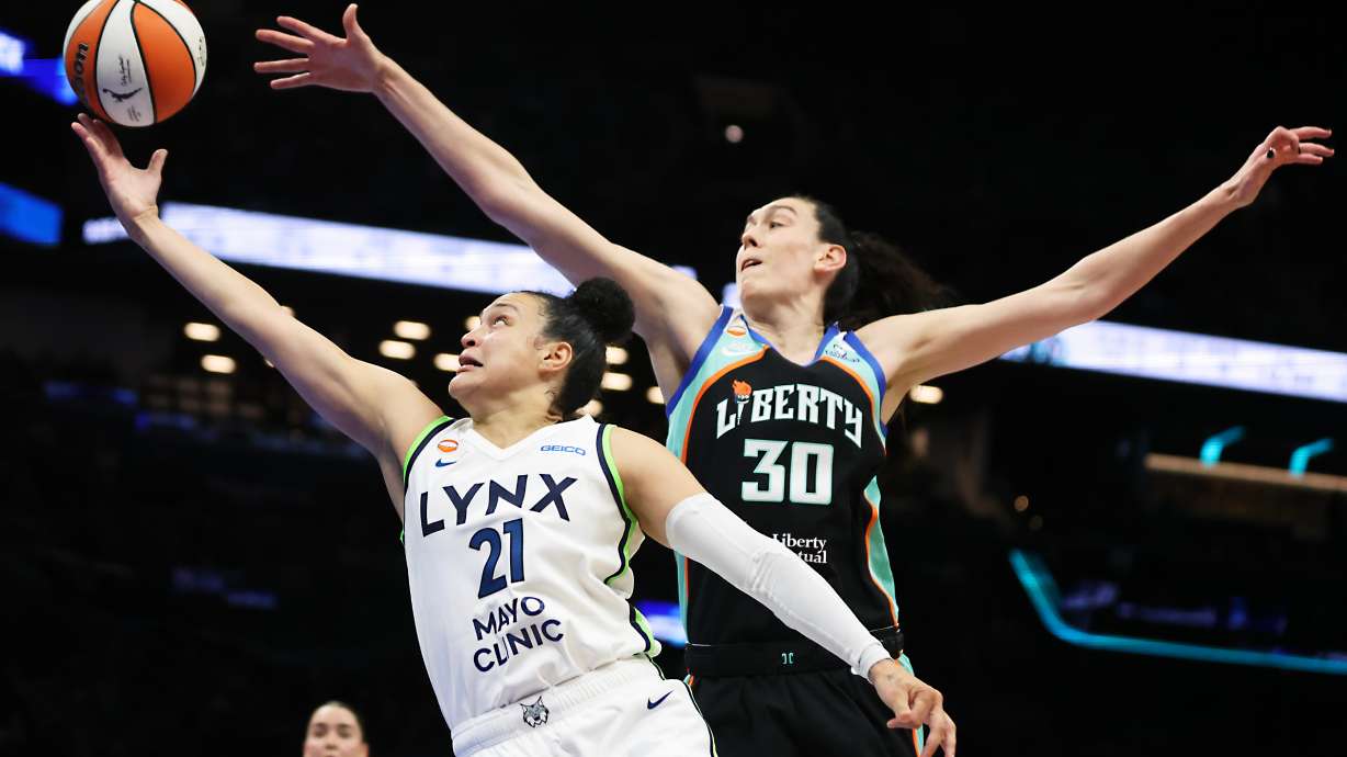 Minnesota Lynx guard Kayla McBride (21) drives to the basket past New York Liberty forward Breanna Stewart (30) during the first half of Game 2 of a WNBA basketball first-round playoff series, Tuesday, Sept. 29, 2026, in New York.