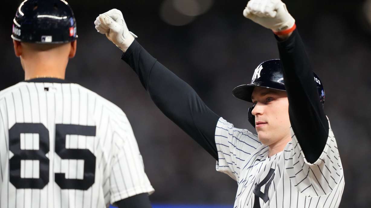 New York Yankees' Ben Rice, right, reacts next to first base coach Dan Fiorito, after collecting an RBI on a bases loaded single against the Boston Red Sox during the seventh inning in Game 1 of baseball's American League Wild Card Series, Tuesday, Sept. 29, 2026, in New York.