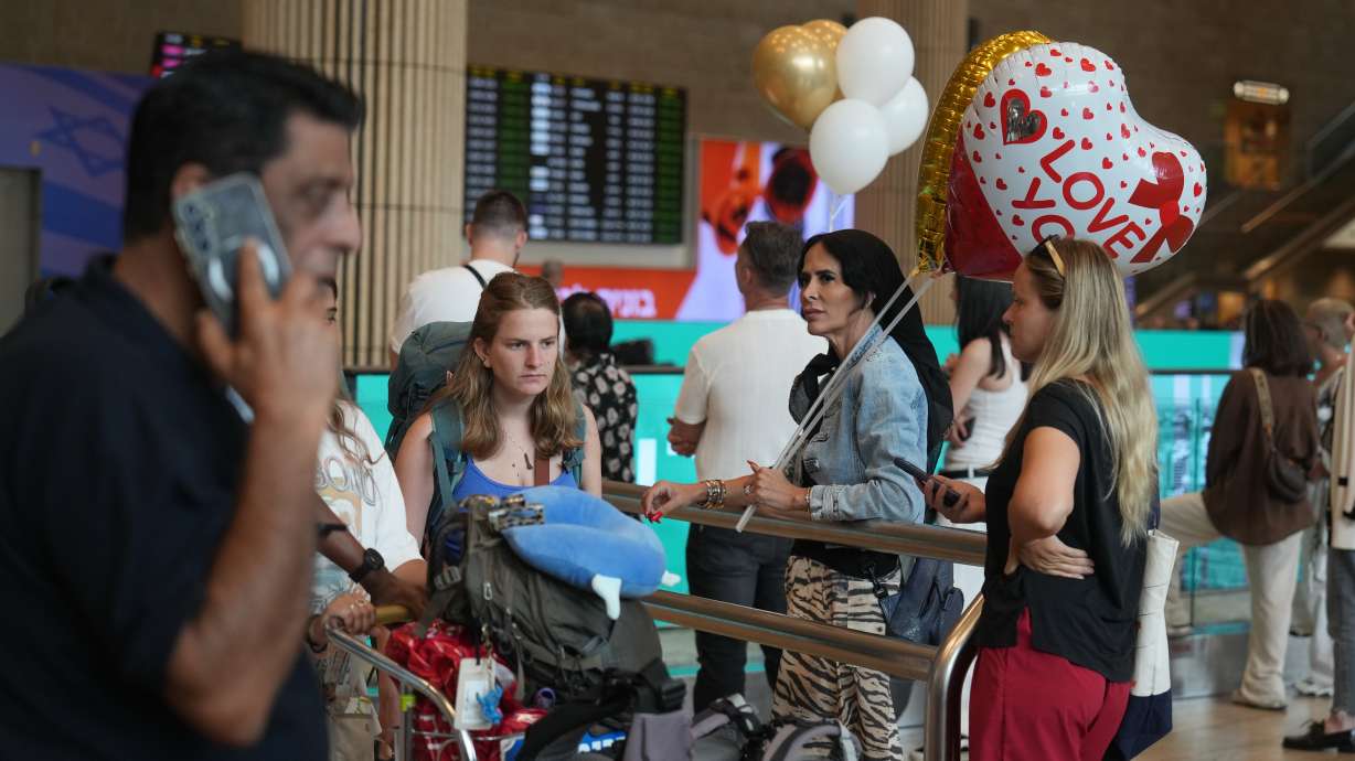 People wait for passengers to arrive at Ben Gurion International Airport, near Tel Aviv, Israel, on Wednesday. A pilot on a FlyDubai flight stabbed another pilot and then apparently tried to crash the aircraft carrying dozens of Israelis.