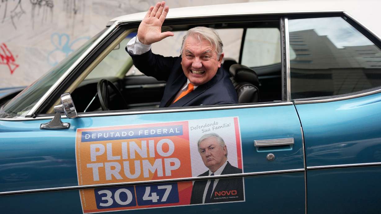 Plinio Vicentin Jr., who is running for federal lawmaker as "Plinio Trump," with the Novo Party representing Minas Gerais state, campaigns from his car ahead of the general election in Juiz de Fora, Minas Gerais state, Brazil, on Monday. Whether called protest candidates or joke candidates, they are part of a Brazilian tradition that spans nearly eight decades and brings a surreal element to congressional elections.