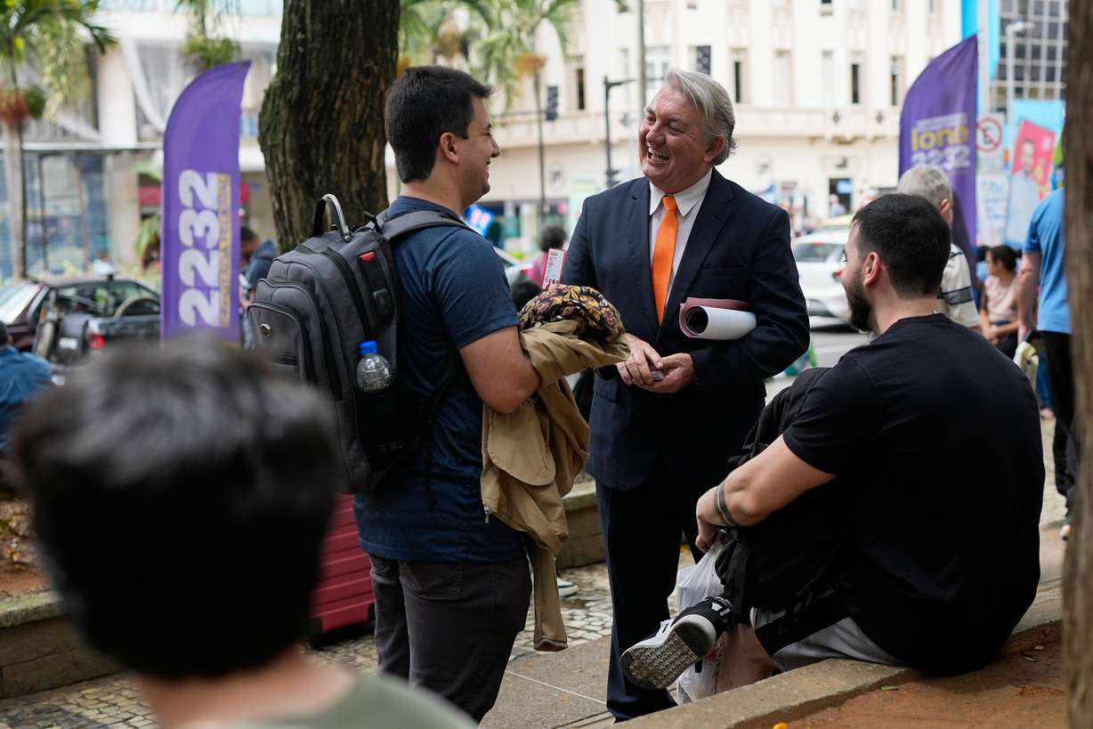 Plinio Vicentin Jr., center, who is running for federal lawmaker as "Plinio Trump," with the Novo Party representing Minas Gerais state, campaigns ahead of the general election in Juiz de Fora, Minas Gerais state, Brazil, on Monday.
