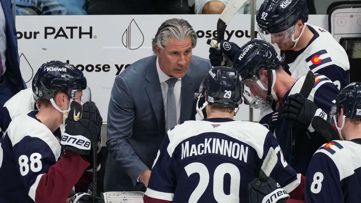 FILE - Colorado Avalanche head coach Jared Bednar, center, draws up a play during a time out in the third period of an NHL hockey game against the Minnesota Wild, Feb. 26, 2026, in Denver.