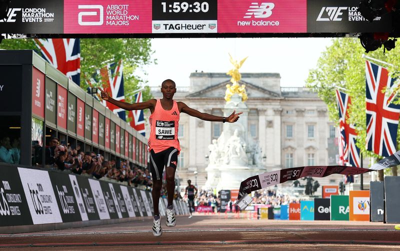 FILE PHOTO: Athletics - London Marathon - London, Britain - April 26, 2026 Kenya's Sabastian Sawe crosses the finish line to win the men's elite race