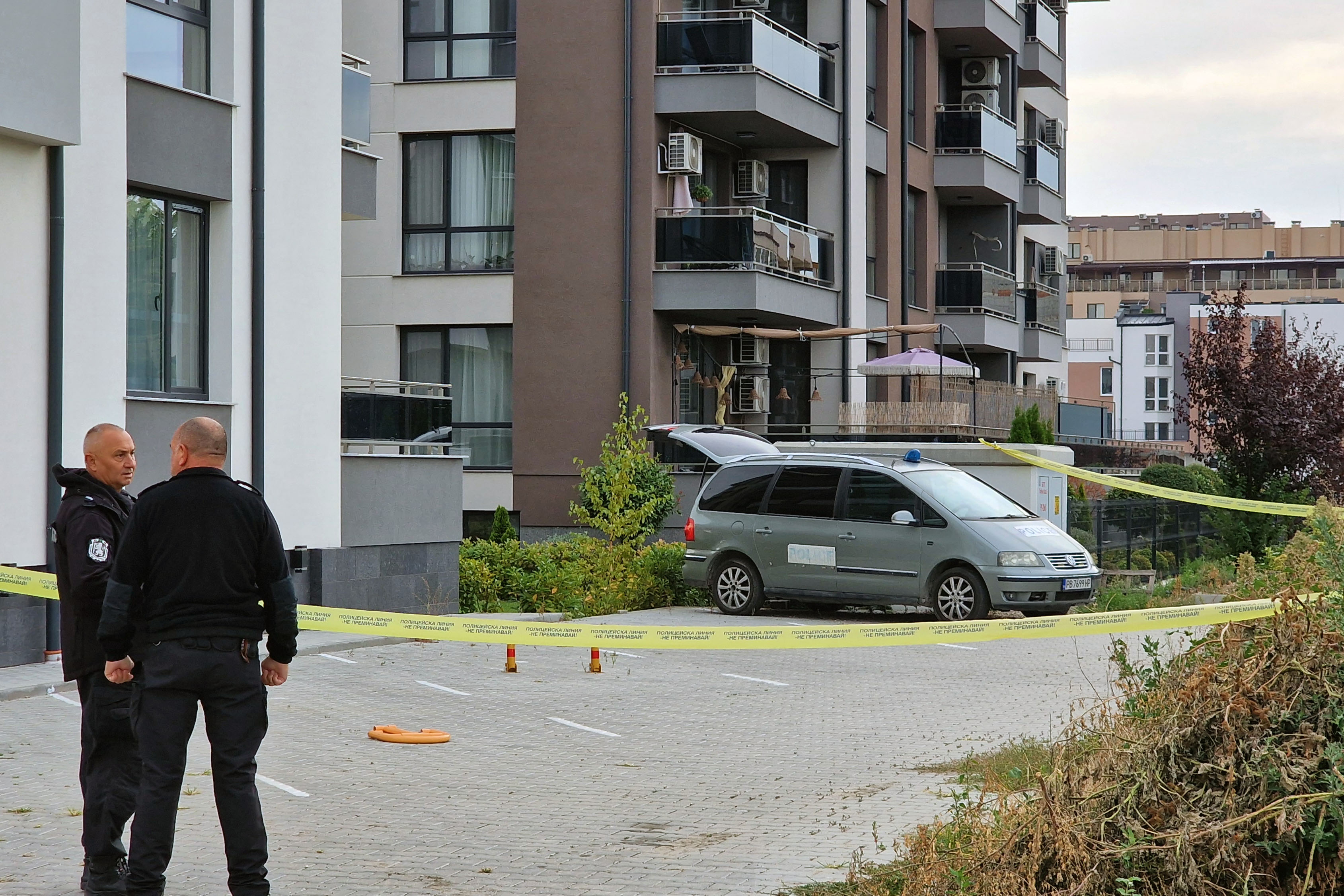 Police officers stand guard beside a police laboratory vehicle on Wednesday, Sept. 30, 2026, in Plovdiv, during an investigation into the murder of Botev Plovdiv's President and prominent businessman Iliyan Filipov, 53, who was shot dead early Wednesday near his home, police said. 