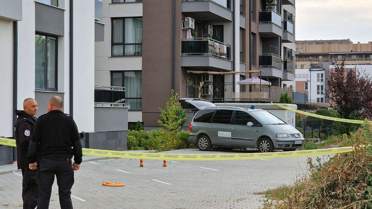 Police officers stand guard beside a police laboratory vehicle on Wednesday, Sept. 30, 2026, in Plovdiv, during an investigation into the murder of Botev Plovdiv's President and prominent businessman Iliyan Filipov, 53, who was shot dead early Wednesday near his home, police said.