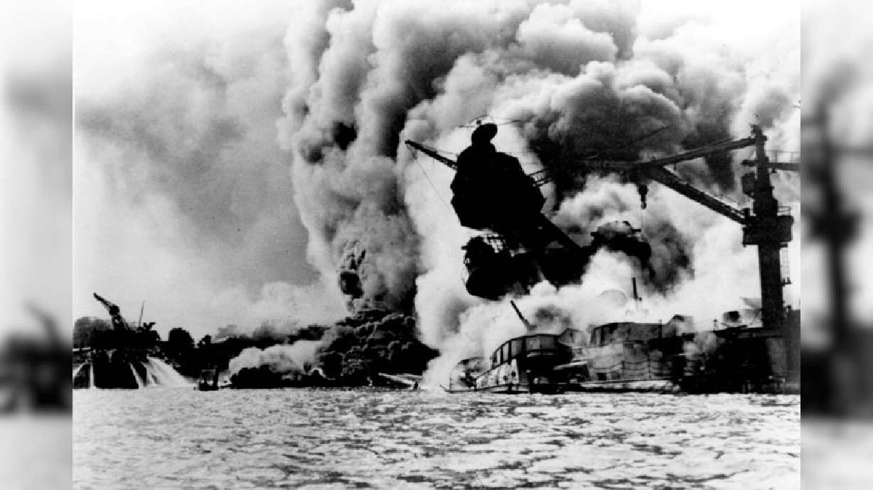 The USS Arizona in flames after the Japanese attack on Pearl Harbor in Pearl Harbor, Hawaii, on Dec. 7, 1941. A Utah woman is helping the government identify and trace the hundreds killed in Pearl Harbor.