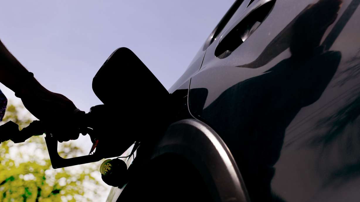 A man fills his car with gasoline at a Smith’s in Salt Lake City on April 19, 2024. The average gas price hit $5 per gallon in Utah as the latest federal report found the price increases on consumer goods and services cooled, though is still running above the Fed's target.