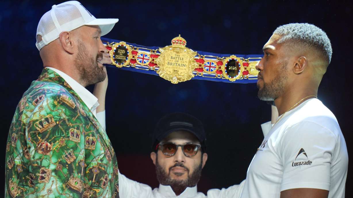Tyson Fury, left, and Anthony Joshua, right, face off after a Press Conference in London, Wednesday, Sept. 30, 2026, to promote their upcoming fight which will take place at the Principality Stadium in Cardiff on Dec.11.