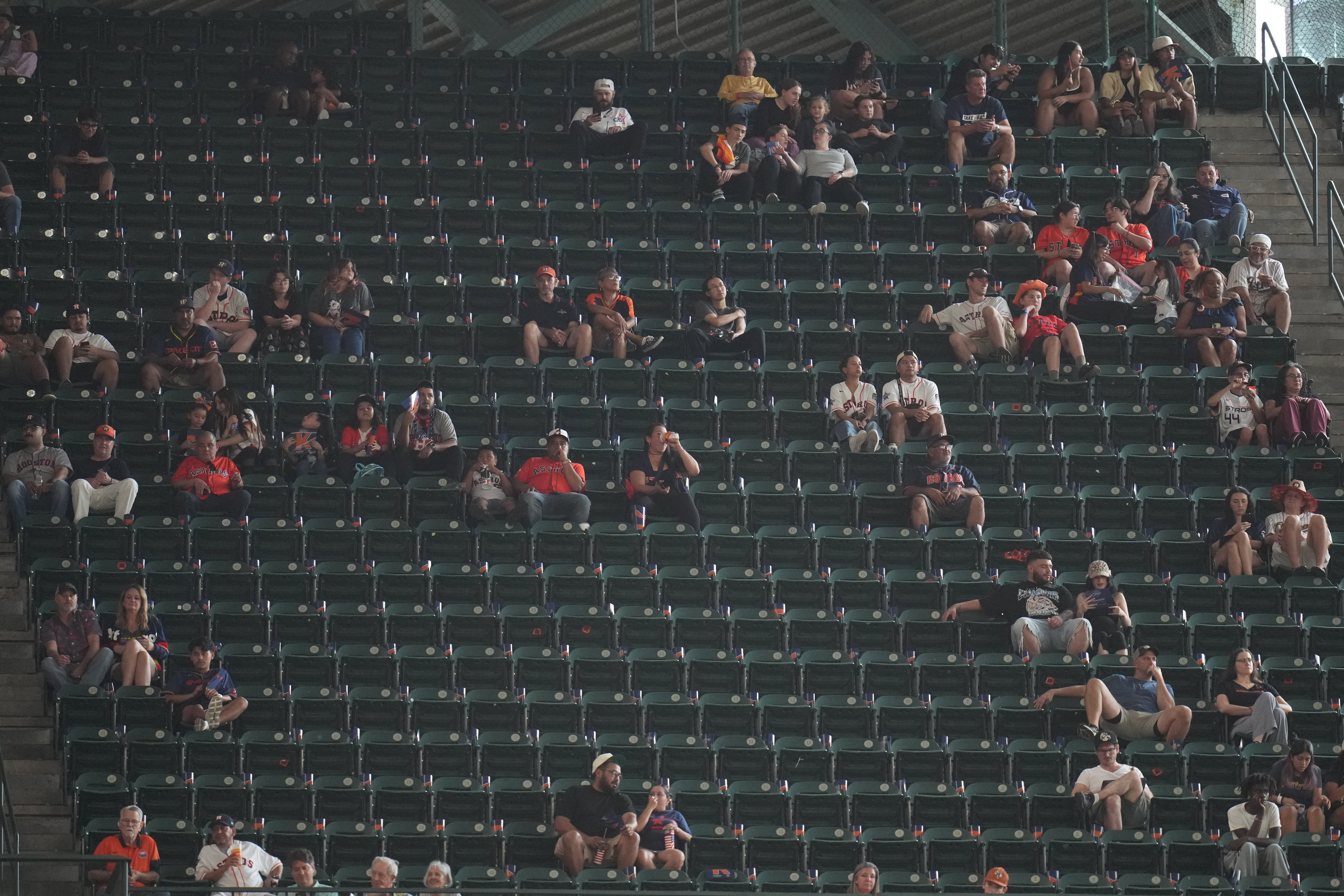 Fans sit among empty seats during the second inning in Game 1 of baseball's American League Wild Card Series between the Houston Astros and Chicago White Sox, Tuesday, Sept. 29, 2026, in Houston. 