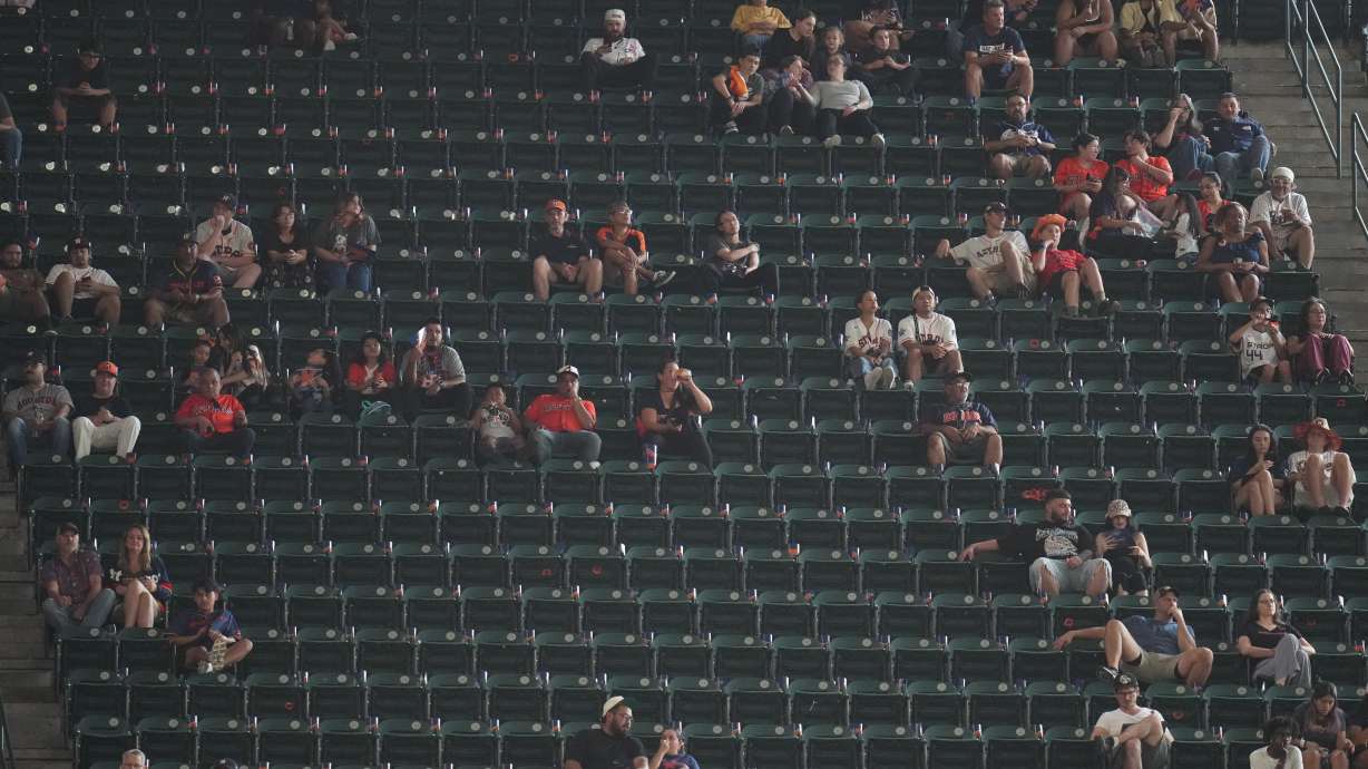 Fans sit among empty seats during the second inning in Game 1 of baseball's American League Wild Card Series between the Houston Astros and Chicago White Sox, Tuesday, Sept. 29, 2026, in Houston.