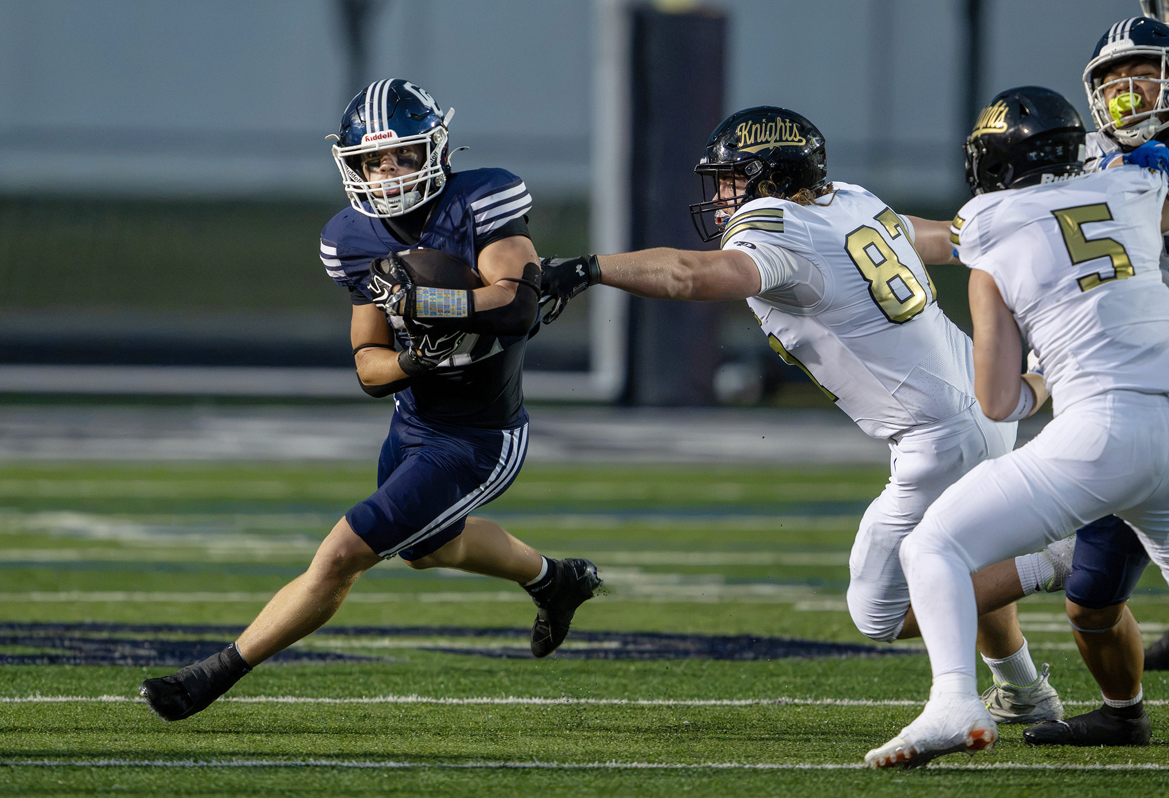 Corner Canyon’s Jackson Carruth runs around the corner with Lone Peak’s Cubby Hoyal trying to grab onto him as they play in Draper on Friday, Sept. 18, 2026.