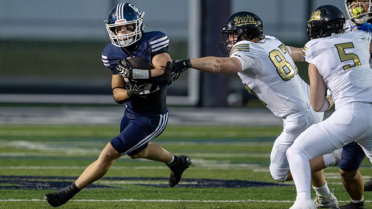 Corner Canyon’s Jackson Carruth runs around the corner with Lone Peak’s Cubby Hoyal trying to grab onto him as they play in Draper on Friday, Sept. 18, 2026.