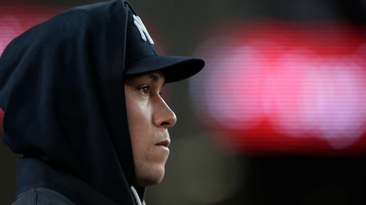 New York Yankees' Aaron Judge looks on from the dugout during the second inning in Game 1 of baseball's American League Wild Card Series against the Boston Red Sox, Tuesday, Sept. 29, 2026, in New York.