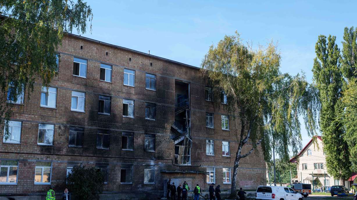 Police officers look at a school damaged by a Russian drone strike in Kyiv, Ukraine, Thursday. No one was killed or injured as all the children and staff were in shelters.