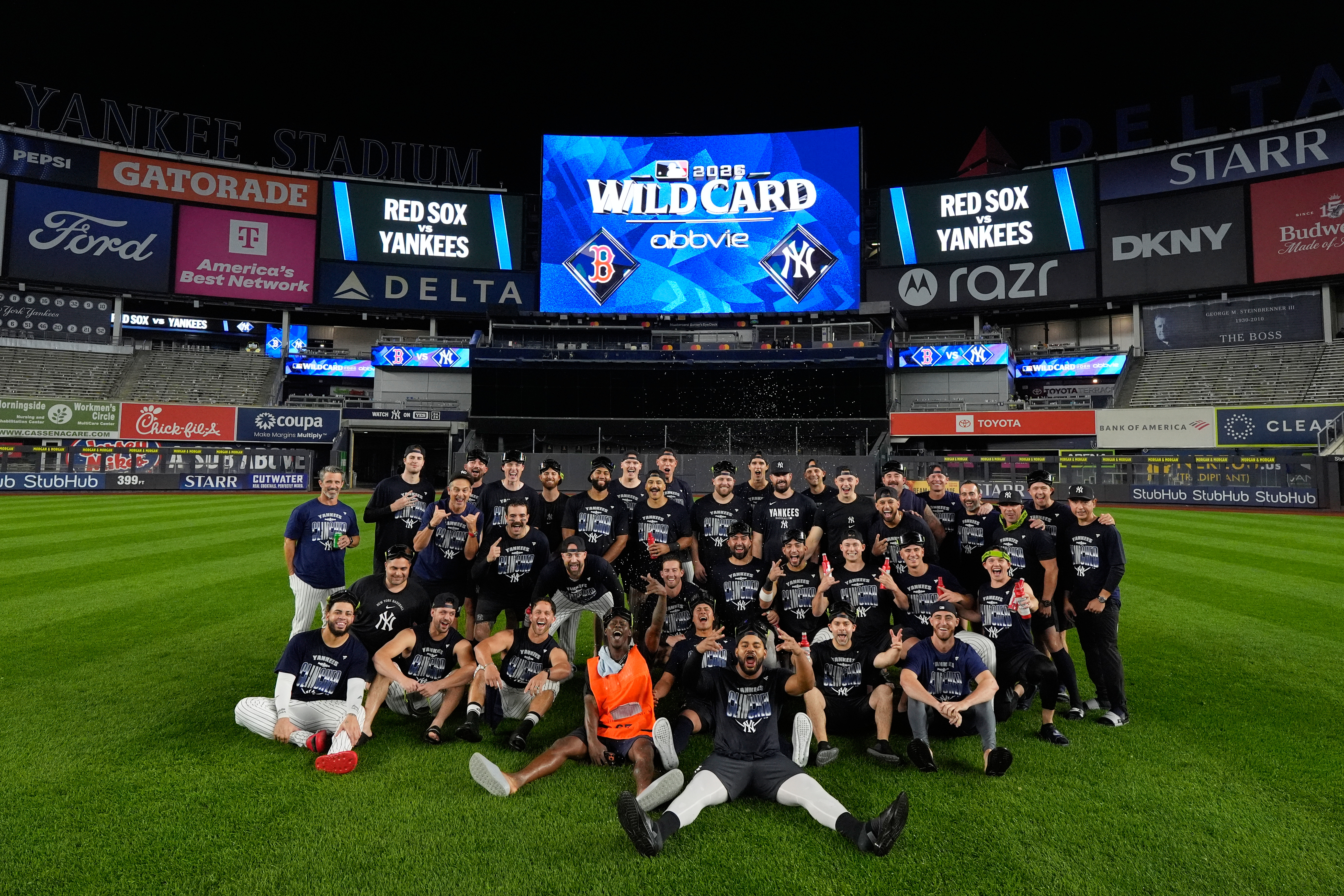 The New York Yankees take a group photo on the field to celebrate after winning baseball's American League Wild Card Series against the Boston Red Sox in Game 2, Wednesday, Sept. 30, 2026, in New York. 