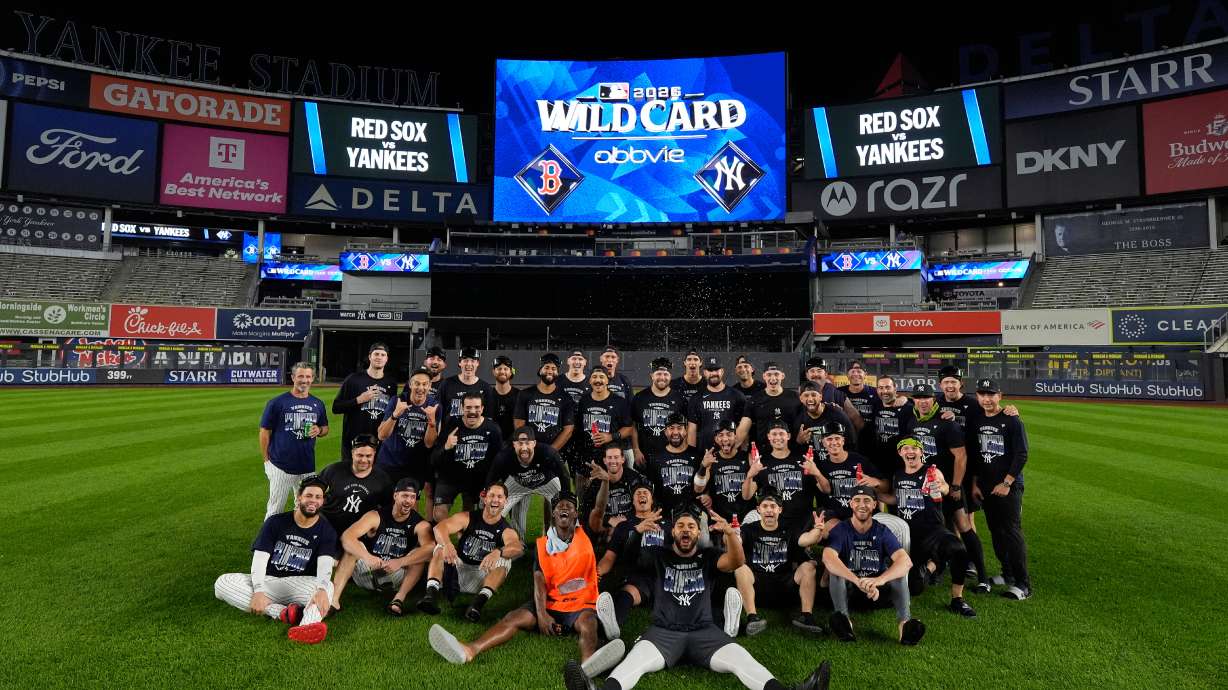 The New York Yankees take a group photo on the field to celebrate after winning baseball's American League Wild Card Series against the Boston Red Sox in Game 2, Wednesday, Sept. 30, 2026, in New York.
